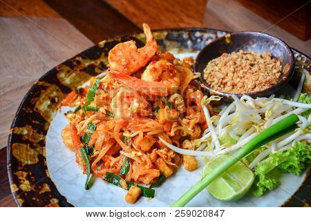 Thai Food, Stir Fry Rice Noodles With Shrimps, Tofu, Vegetable And Crushed Peanuts Or Pad Thai On Wo