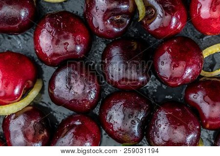 Precious Red And Fresh Cherry Pints, Fresh And Raw On A Textured And Veined Black Background. With L