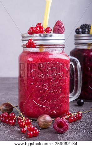 Summer Smoothies Of Raspberries, Red Currant, Goosberries In Glasse On Grey Concrete Background.