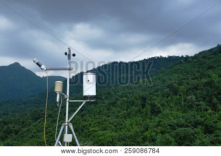 Pluviometer Or Rain Gauge In Mountain Background With Rain Cloud On Sky