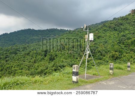 Pluviometer Or Rain Gauge In Mountain Background With Rain Cloud On Sky