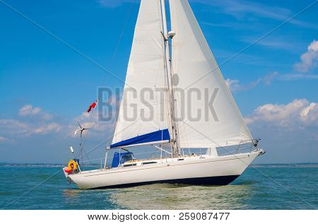 Sailing boat, sail boat or yacht at sea with white sails