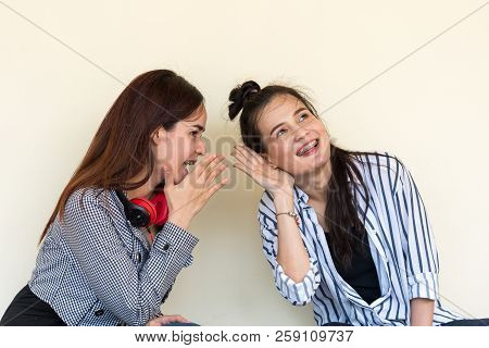 Two Pretty Cuter Teenagers  Sit And Watch Phone To Shares Secrets With Gossip And Entertainment At O