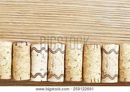 A Row Of Used Wine Corks On A Old Wooden Table. Top View. Selective Focus On Corks.