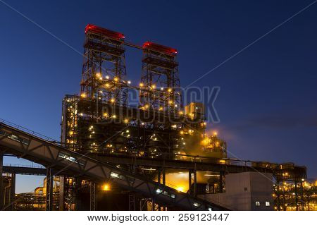 Night Industrial Landscape With Bright Lights Of Lanterns - 4-drum Delayed Coking Unit In A Petroleu