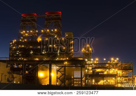 Night Industrial Landscape With Bright Lights Of Lanterns - 4-drum Delayed Coking Unit In A Petroleu