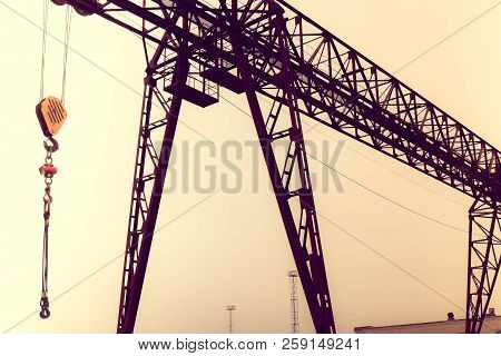 Industrial Iron Large Metal Gantry Crane With A Hook Mounted On The Supports For Lifting And Carryin