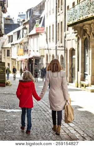 Happy Mother And Daughter At The City