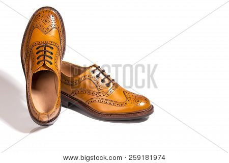 A Pair Of Luxury Male Full Brogued Tan Oxford Shoes. Isolated Over White Background.horizontal Image