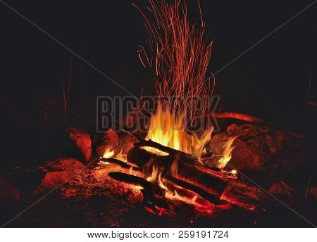A Close Up Of The Aflame Bonfire With Sparks.