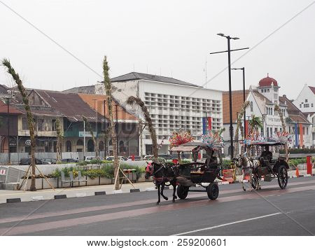 Jakarta, Indonesia - August 7, 2018: Two Delmans (horse Drawn Carriage) Running On Jalan Kali Besar 