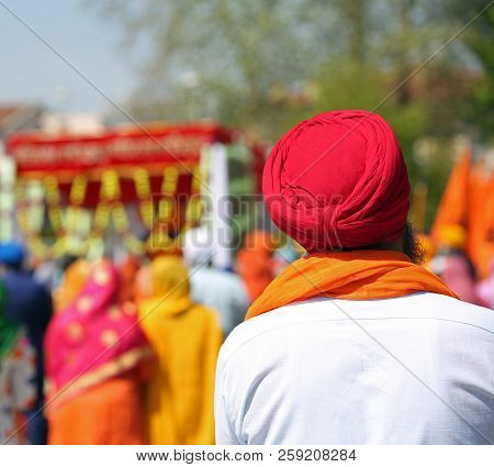 Sikh Man With Red Turban During An Outdoor Parade