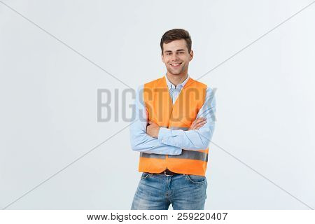 Happy Engineer Smiling And Standing Confidently, Guy Wearing Caro Shirt And Jeans With Orange Vest, 