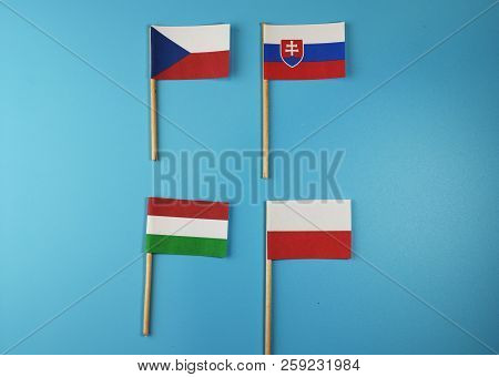Visegrad Group On Wooden Stick. There Are Czech Republic, Slovakia, Hungaria And Poland. Blue Backgr