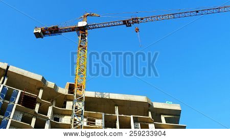 Crane. Construction Crane. Building Crane On The Background Of  A Building.