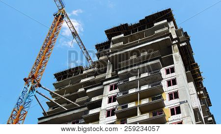 Construction Site. Industrial Crane Near Building. Building Under Construction.