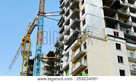 Construction Site. Two Tower Cranes Near Building.