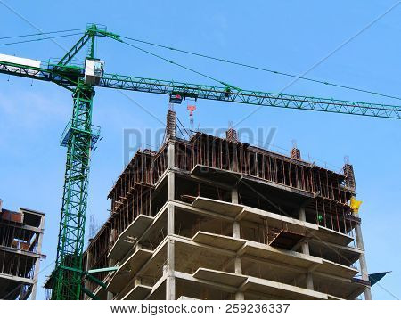 Crane Near Building Against Blue Sky. Construction Site Background