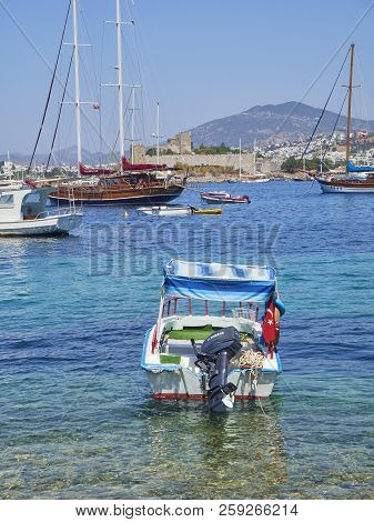 Bodrum, Turkey - July 5, 2018. Boats Moored At Kumbahce Bay With The Castle Of Saint Peter In The Ba