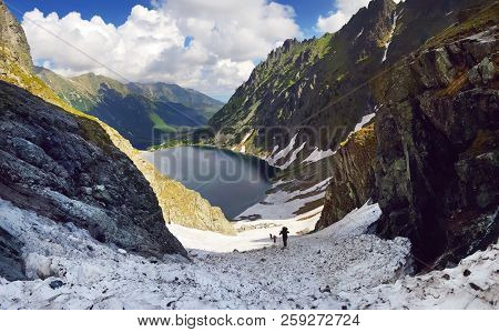 Morskie Oko. High Tatras, Poland, May 27, 2018. Beautiful landscape of snowy mountain tops and the lake between them. View from the mountain Rysy.