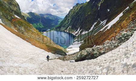Morskie Oko. High Tatras, Poland, May 27, 2018. Beautiful landscape of snowy mountain tops and the lake between them. View from the mountain Rysy.