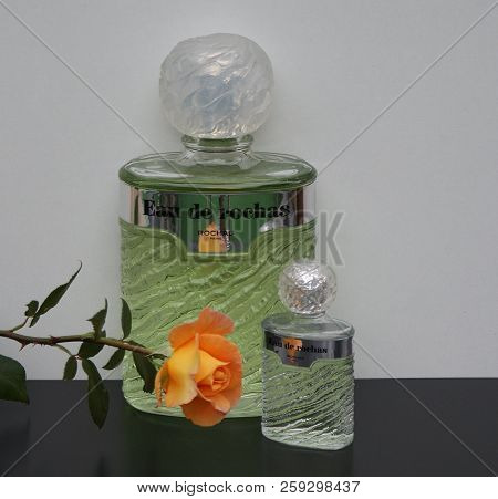 Eau De Rochas, Fragrance For Ladies, Large Perfume Bottle Next To A Commercial Perfume Bottle Decora