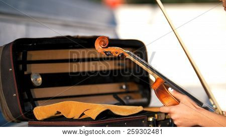 The Hands Put The Violin In The Case