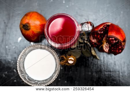 Close Up Of Pomegranate Shrbat Or Juice With Milk,pomegranate Essence,sugar And Raw Pomegranate On W