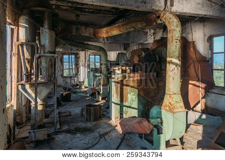 Abandoned Flour Milling Factory. Rusty Broken Pipeline And Mechanisms