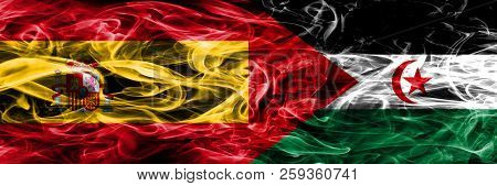 Spain Vs Sahrawi Smoke Flags Placed Side By Side. Thick Colored Silky Smoke Flags Of Spanish And Sah