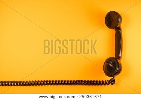 Old Telephone Handset Of The Early Twentieth Century Isolated With Its Elastic Spiral Cable On Neutr