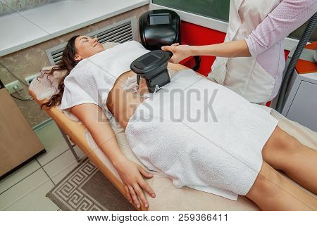 Woman Getting Cryolipolysis Fat Treatment Procedure In Professional Cosmetic Cabinet Or Spa Center