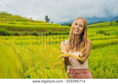 Young Woman Traveler On Beautiful Jatiluwih Rice Terraces Against The Background Of Famous Volcanoes