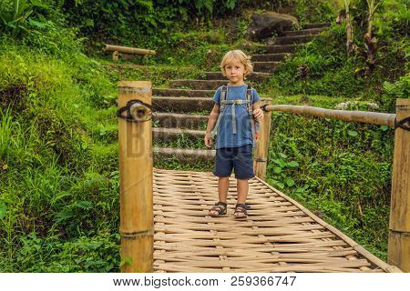 Boy Traveler On Beautiful Jatiluwih Rice Terraces Against The Background Of Famous Volcanoes In Bali
