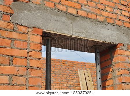 Concrete Door Lintel Installation With Metal Holders. Door Concrete Lintel On Brick Unfinished House