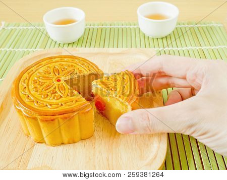Hand Picking Durian Mooncake With Salted Egg Yolk On Mid-autumn Festival Or Mooncake Festival