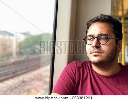 Contemplative man looking out the window on the train