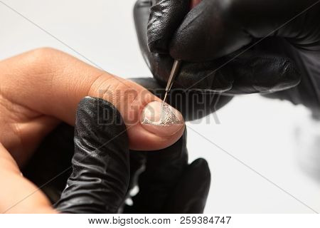 Close-up Of Professional Manicurist Hands Painting Elegant Abstract Silver Glitter Pattern On Client