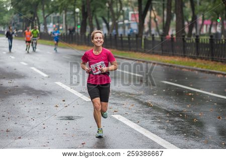 Dnipro, Ukraine - September 16, 2018: Happy Female Participant Running On Dnipro City Street During 