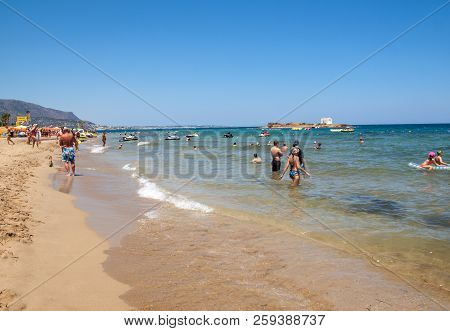 Malia, Crete, Greece - July 1, 2018: People Are Resting On A Sunny Day At The Beach In Malia, Crete,