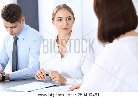 Group Of Business People Or Lawyers Discussing  Terms Of Transaction In Office. Meeting And Teamwork