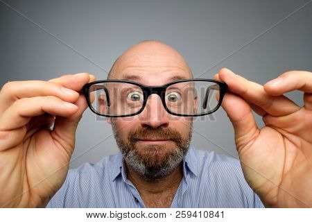 Funny European Man Looking Through Glasses. Have Problems With Eyesight.