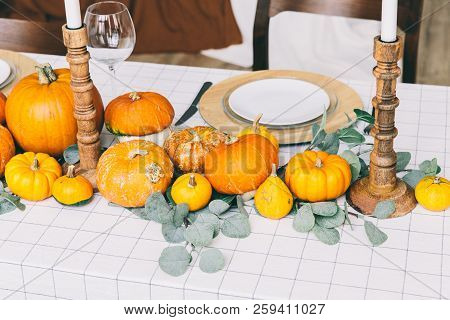 Orange Pumpkins On White Table In Cafe