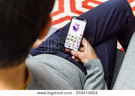 London, Uk - Sep 21, 2018: Man Using The New Ar Memoji Emoji Face On Apple Iphone Xs With The Immens