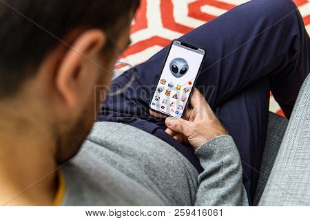 London, Uk - Sep 21, 2018: Man Using The New Alien Ufo Ar Memoji Emoji Face On Apple Iphone Xs With 