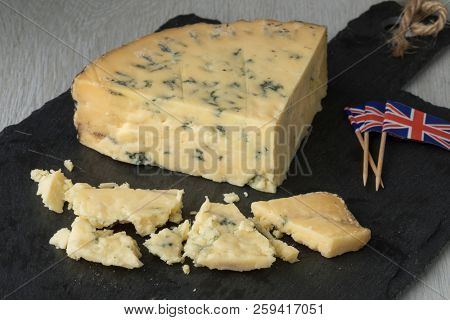 Old mature wedge of British blue Stilton cheese and pieces