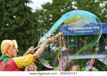 Bosco The Jester Produces A Large Bubble For Spectators