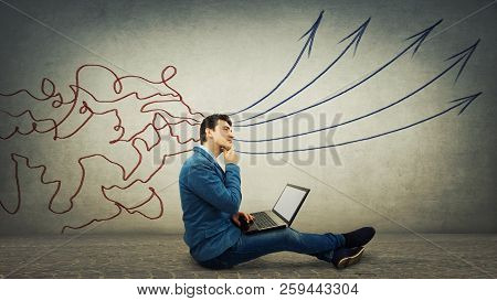 Pensive Businessman Sitting Down On Floor Using Laptop, Thinking About New Projects. Concept Of Info