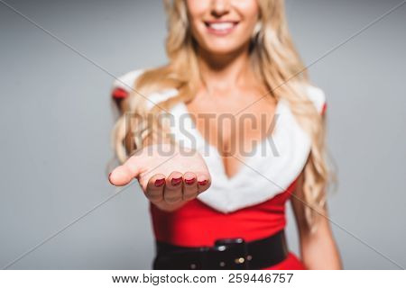Partial View Of Woman In Christmas Dress Giving Empty Handpalm Isolated On Grey Background