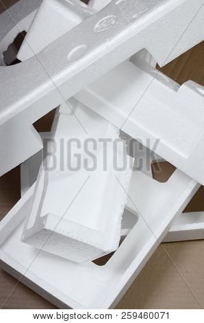 Background Image With Beige Cardboard Paper And Styrofoam Boxes Disgarded As Rubbish. The Concept Of